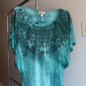 eal blue tie-dye top with floral pattern and textured fabric